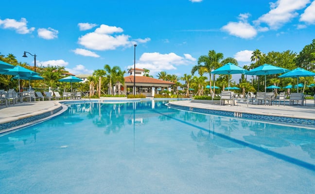 Vista Cay Resort pool with palm trees and turquoise umbrellas, Orlando, Florida