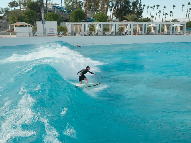 Surfers riding waves in a tropical wave pool