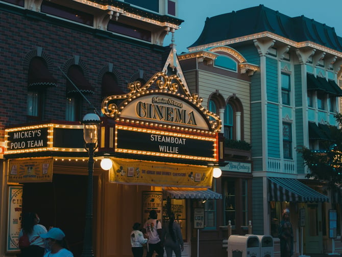 Disney Main Street Cinema at dusk with warm lighting