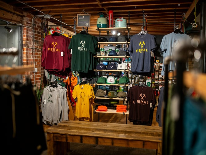 Outdoor gear store interior with clothing racks and brick walls