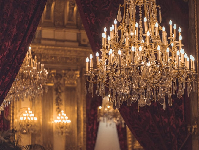 Ornate crystal chandelier in a warm dramatic interior