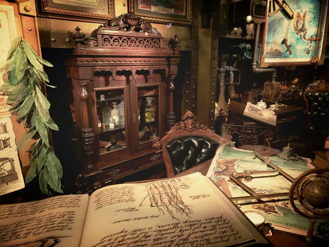 Antique curiosity cabinet with open journal and artifacts