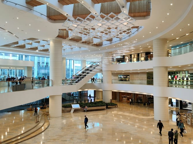 Grand multi-level mall atrium with marble floors