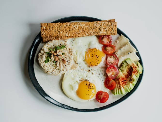 Fresh breakfast bowl with eggs and vegetables